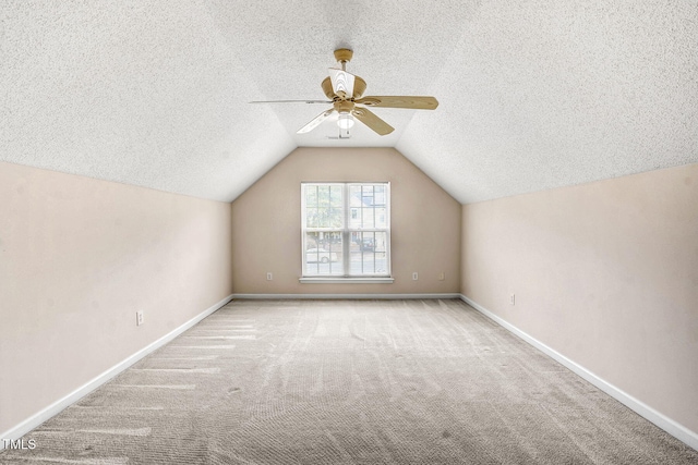 bonus room with a textured ceiling, light carpet, ceiling fan, and vaulted ceiling