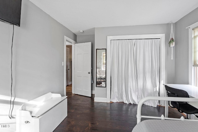 bedroom with dark hardwood / wood-style floors