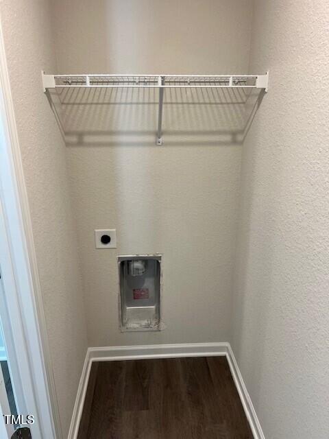 laundry area featuring electric dryer hookup and hardwood / wood-style floors