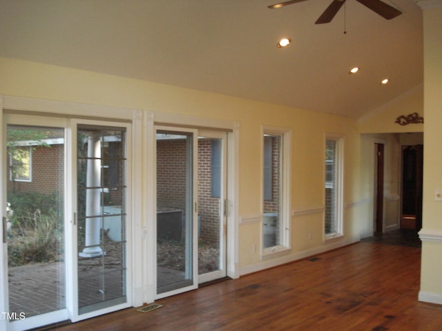 interior space featuring ceiling fan, lofted ceiling, and dark hardwood / wood-style floors