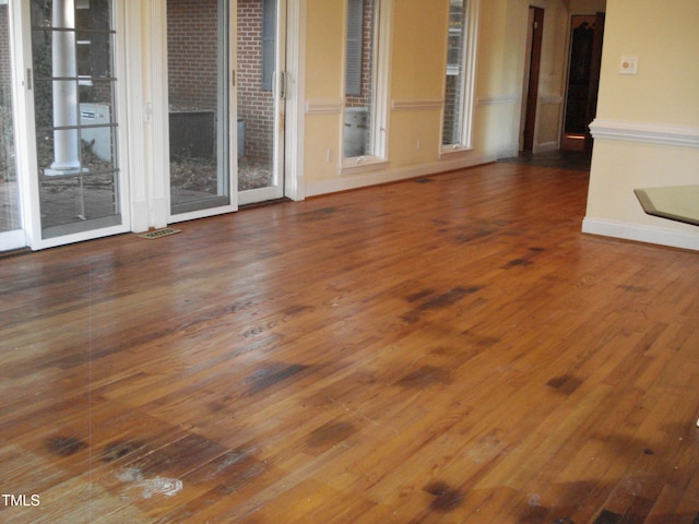 unfurnished living room with dark wood-type flooring