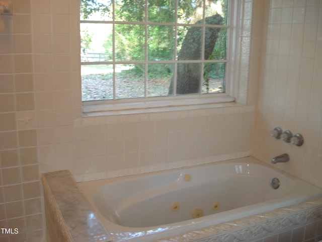 bathroom with tiled tub