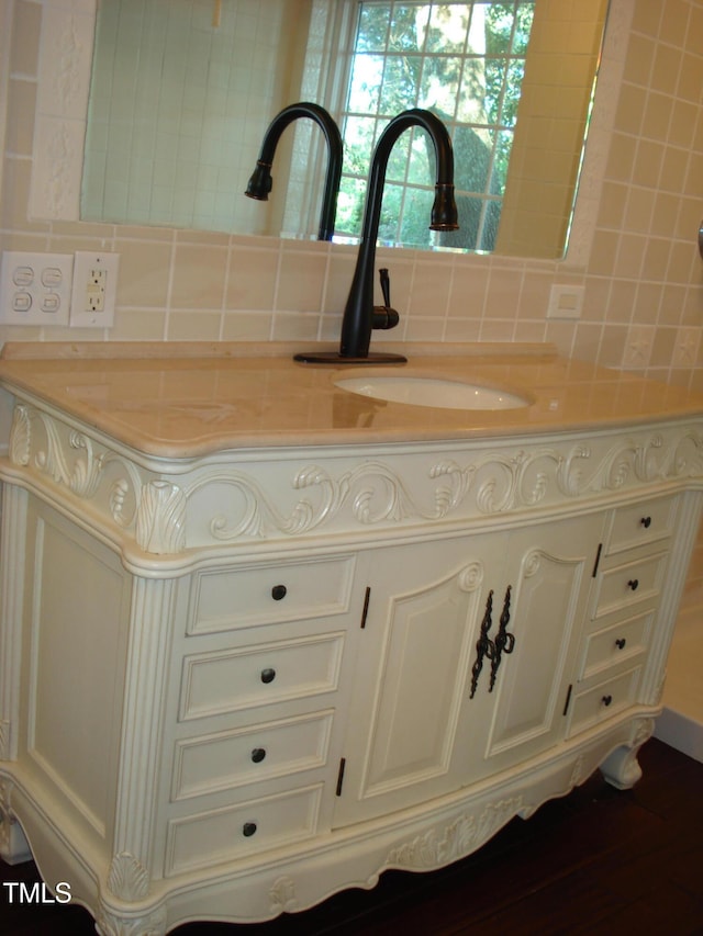 room details with backsplash and wood-type flooring