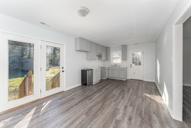 kitchen with gray cabinets and light hardwood / wood-style floors