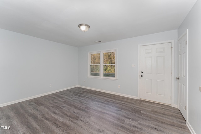 spare room with dark hardwood / wood-style floors