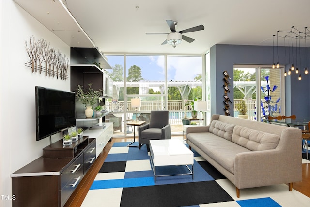 living room featuring ceiling fan, dark hardwood / wood-style floors, and a wall of windows