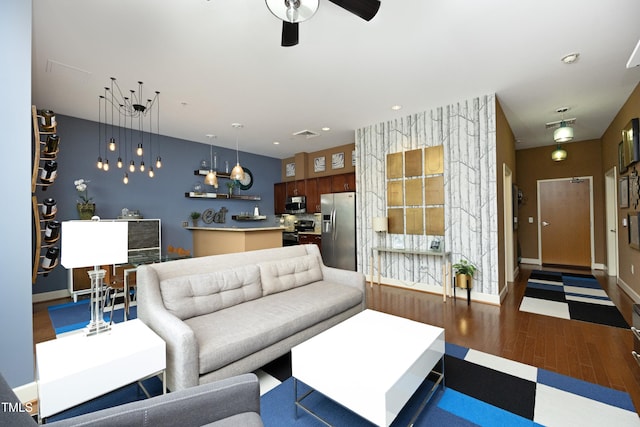 living room featuring dark hardwood / wood-style flooring and ceiling fan