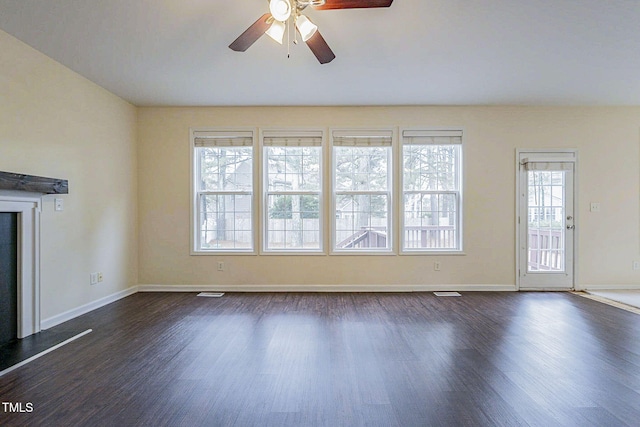 unfurnished living room with ceiling fan and dark hardwood / wood-style flooring