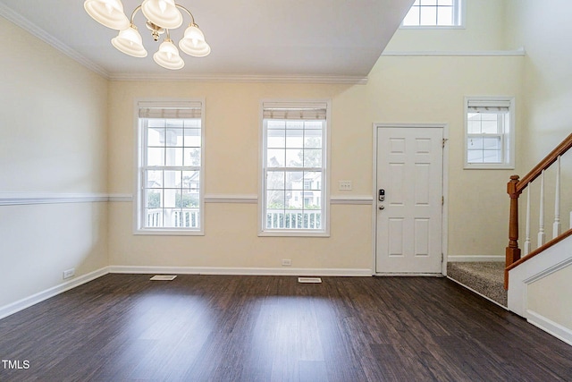 entryway featuring dark wood-type flooring and an inviting chandelier