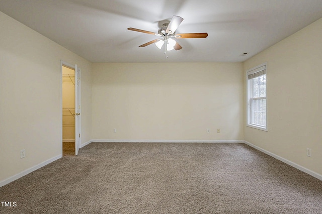 spare room with carpet floors and ceiling fan