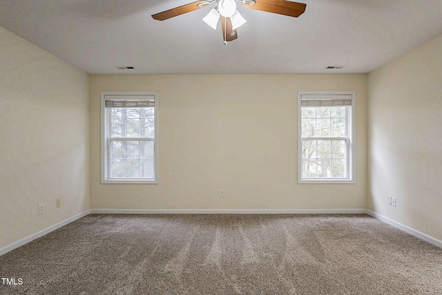 carpeted spare room with ceiling fan