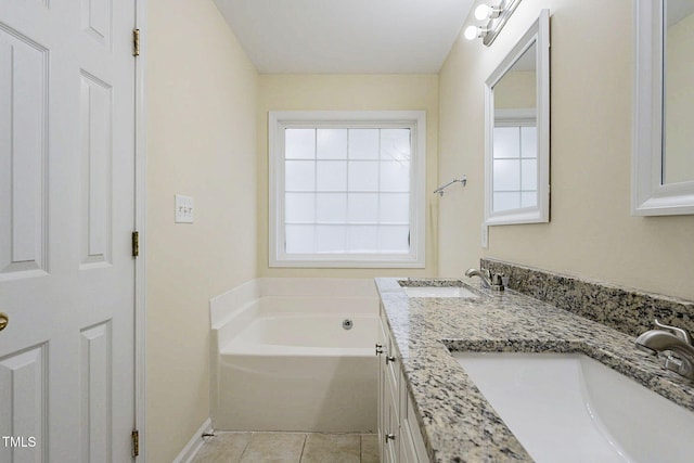 bathroom featuring a bath, vanity, and tile patterned flooring