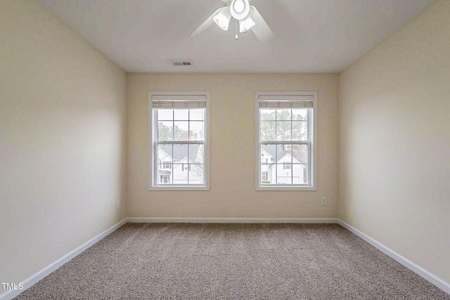 carpeted spare room with ceiling fan