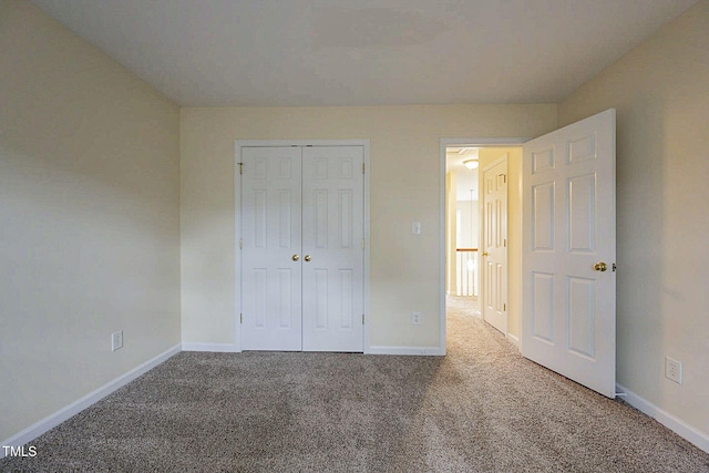 unfurnished bedroom featuring carpet floors and a closet