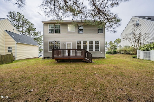 back of house with a wooden deck and a yard