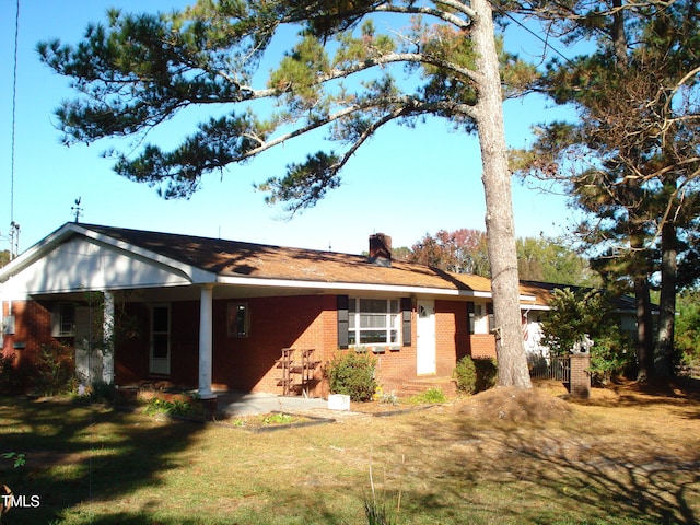 rear view of house with a yard