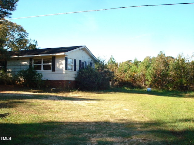 view of home's exterior with a yard