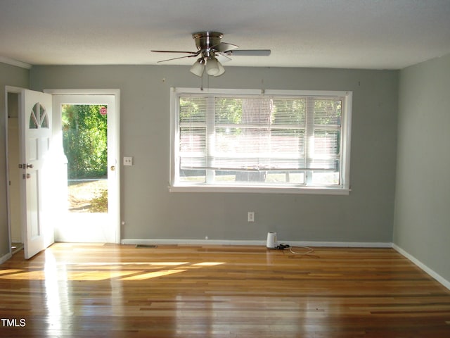 unfurnished room featuring hardwood / wood-style flooring and ceiling fan