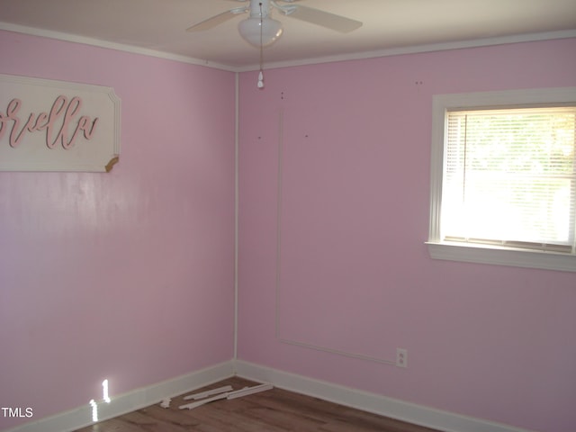 empty room featuring ornamental molding, wood-type flooring, and ceiling fan