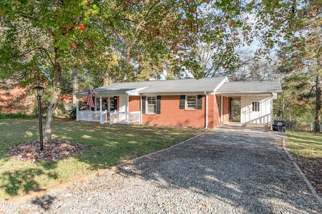 single story home with a front yard, a porch, and a carport