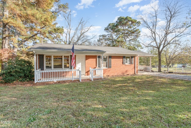 ranch-style home with a front yard and a porch