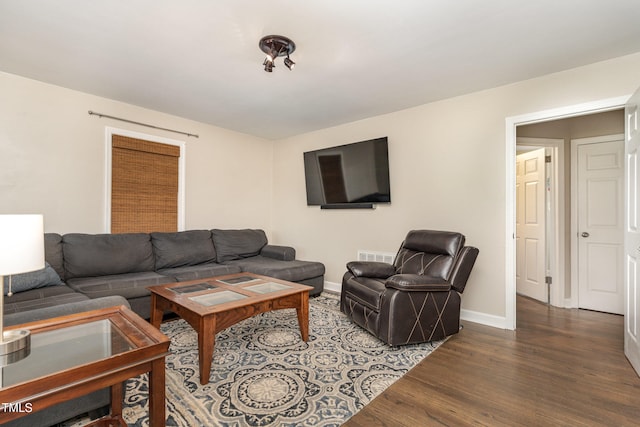 living room with dark hardwood / wood-style flooring