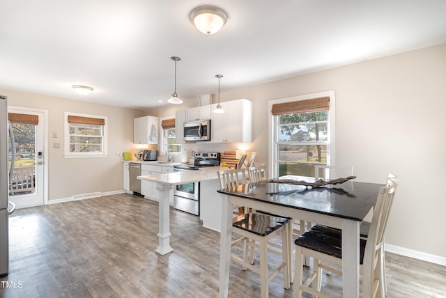 dining room with light wood-type flooring and sink