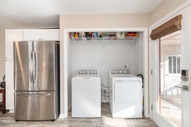 laundry area featuring washer and clothes dryer and hardwood / wood-style flooring