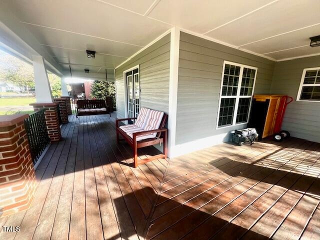 wooden terrace with a porch