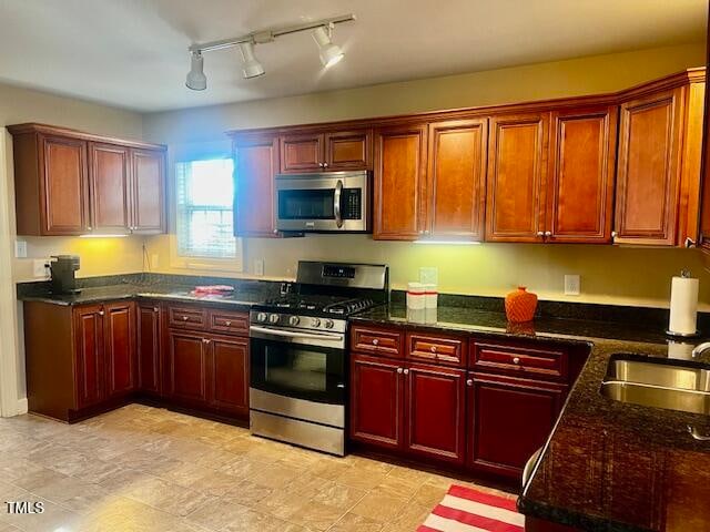 kitchen featuring sink, stainless steel appliances, and track lighting