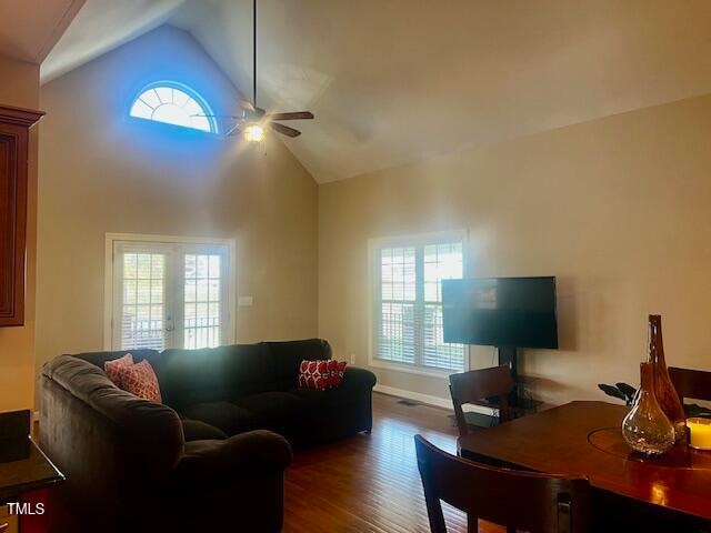 living room featuring ceiling fan, hardwood / wood-style floors, and high vaulted ceiling