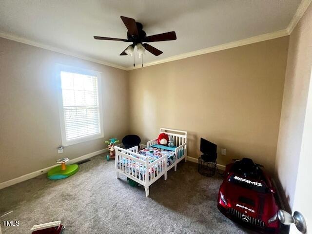 carpeted bedroom featuring ceiling fan and ornamental molding