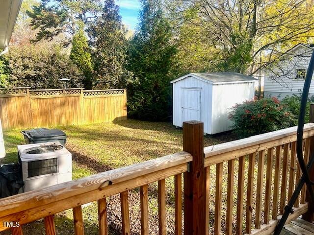 view of yard featuring central air condition unit and a storage shed