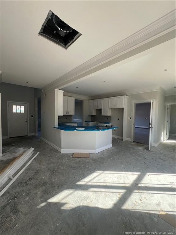 kitchen with white cabinetry and ornamental molding