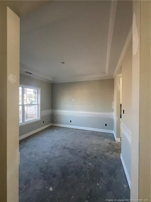 empty room featuring crown molding