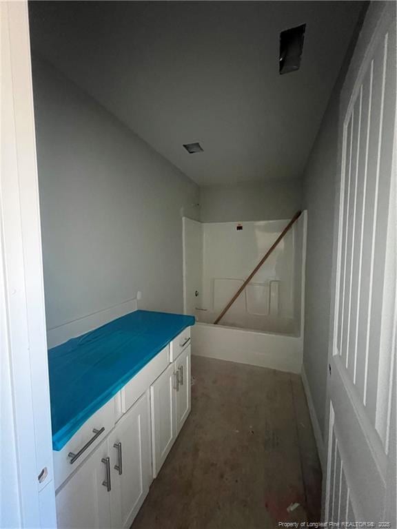 bathroom with vanity, concrete floors, and shower / tub combination