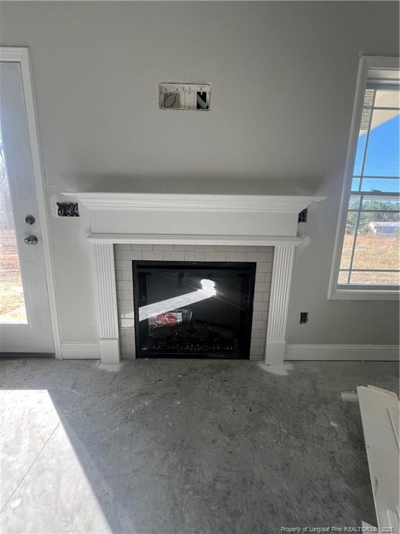 interior details with a fireplace with flush hearth and baseboards