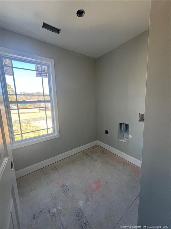 clothes washing area featuring laundry area and baseboards