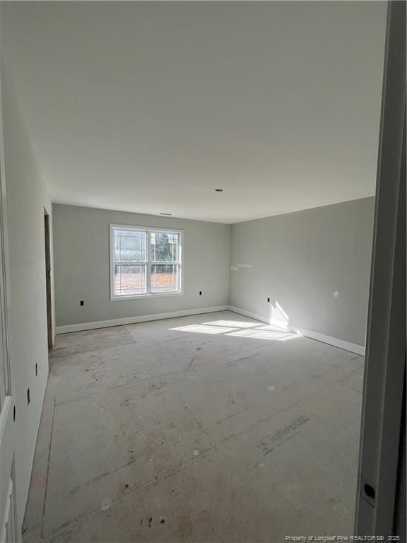 empty room featuring baseboards