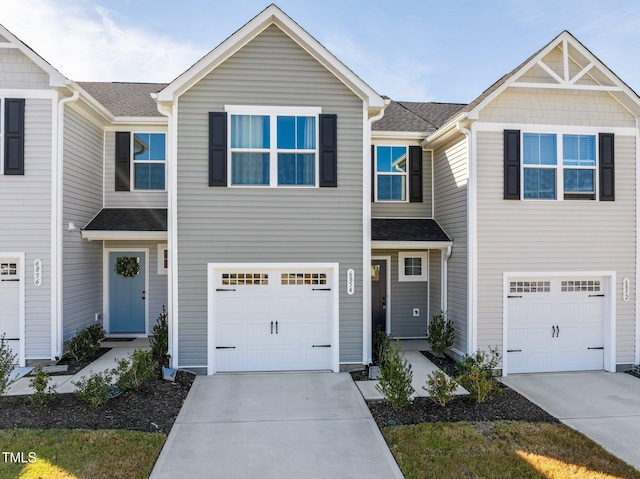 townhome / multi-family property featuring a garage