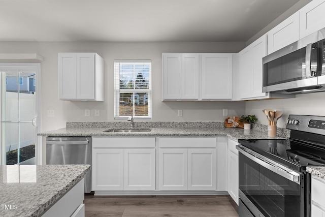 kitchen featuring white cabinets, appliances with stainless steel finishes, and sink