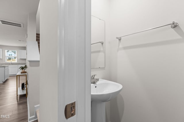 bathroom with hardwood / wood-style floors and sink