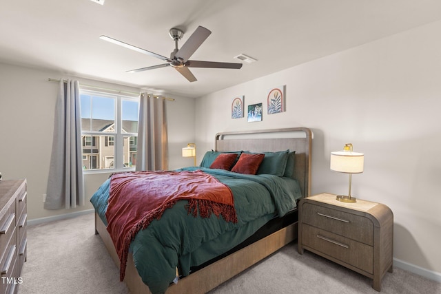 bedroom with ceiling fan and light carpet