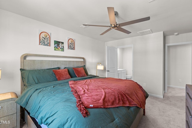 bedroom featuring ceiling fan, light carpet, and connected bathroom