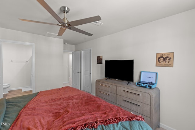 bedroom with ensuite bath, ceiling fan, and hardwood / wood-style floors