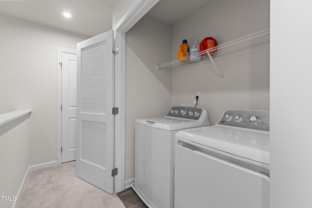 laundry room featuring independent washer and dryer and light carpet