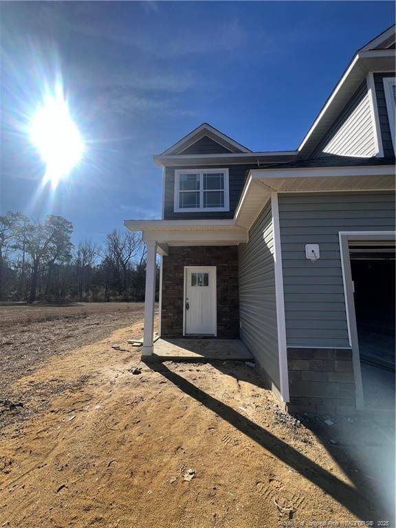 property entrance with stone siding