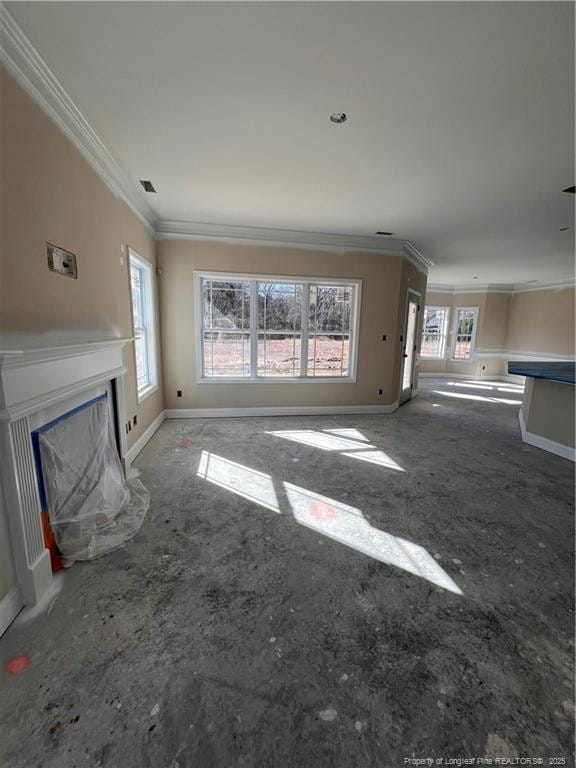 unfurnished living room featuring crown molding, a fireplace with raised hearth, visible vents, and baseboards