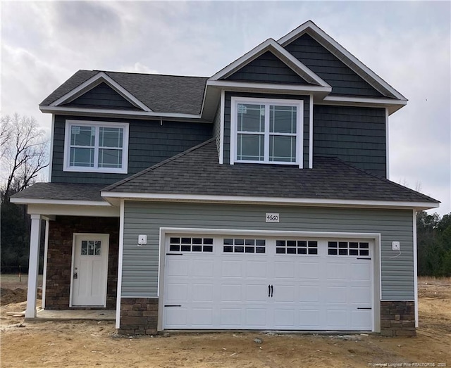 craftsman-style house with stone siding and roof with shingles