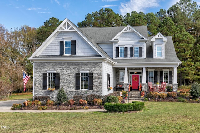 craftsman inspired home with a porch and a front yard